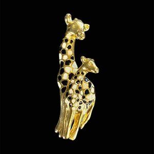 This vintage brooch features a giraffe enamel design in black and gold tones, ma